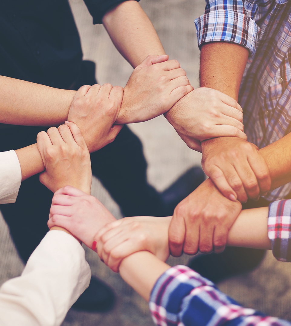 Hands joined together in unity circle.